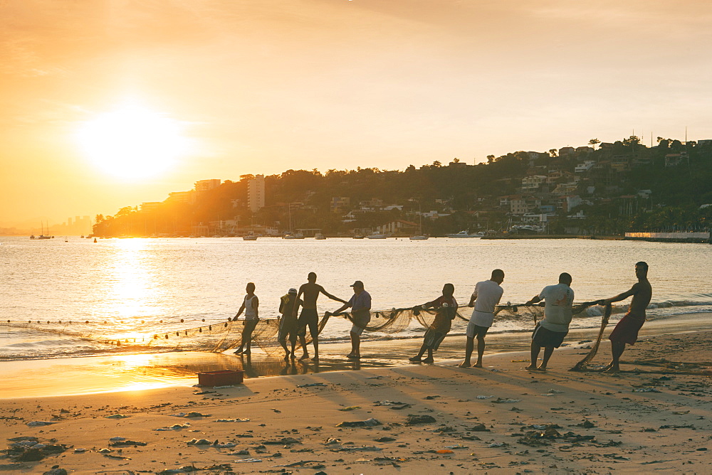 Fishermen on the beach in Niteroi, with the Rio skyline in the background, Rio de Janeiro, Brazil, South America