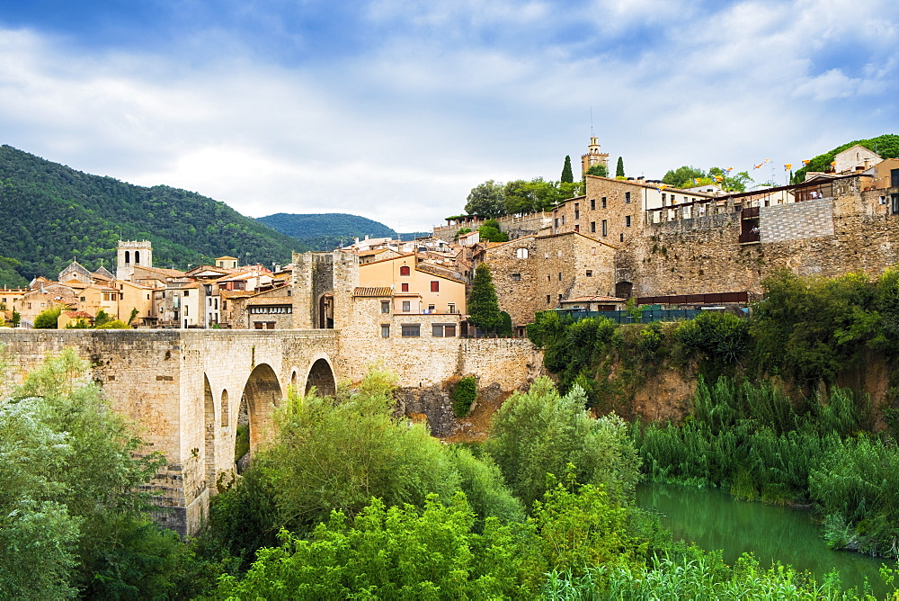 The medieval bridge and fortified old stone city of Besalu in the foothills of the Pyrenees, Besalu, Girona, Catalonia, Spain, Europe