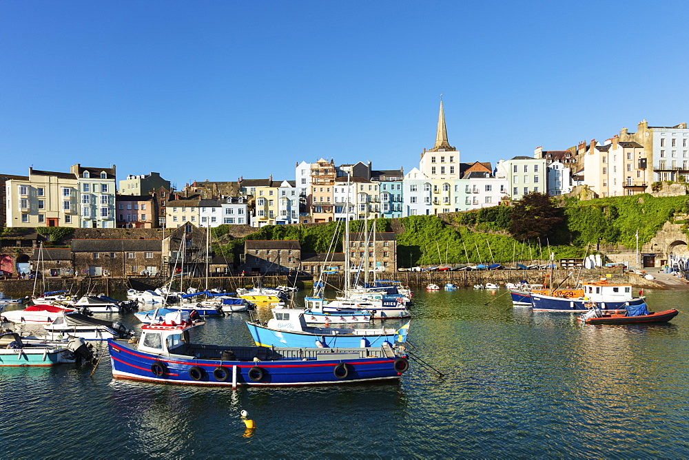 View of the town centre and fishing boats in the harbour, Tenby, Pembrokeshire, Wales, United Kingdom, Europe