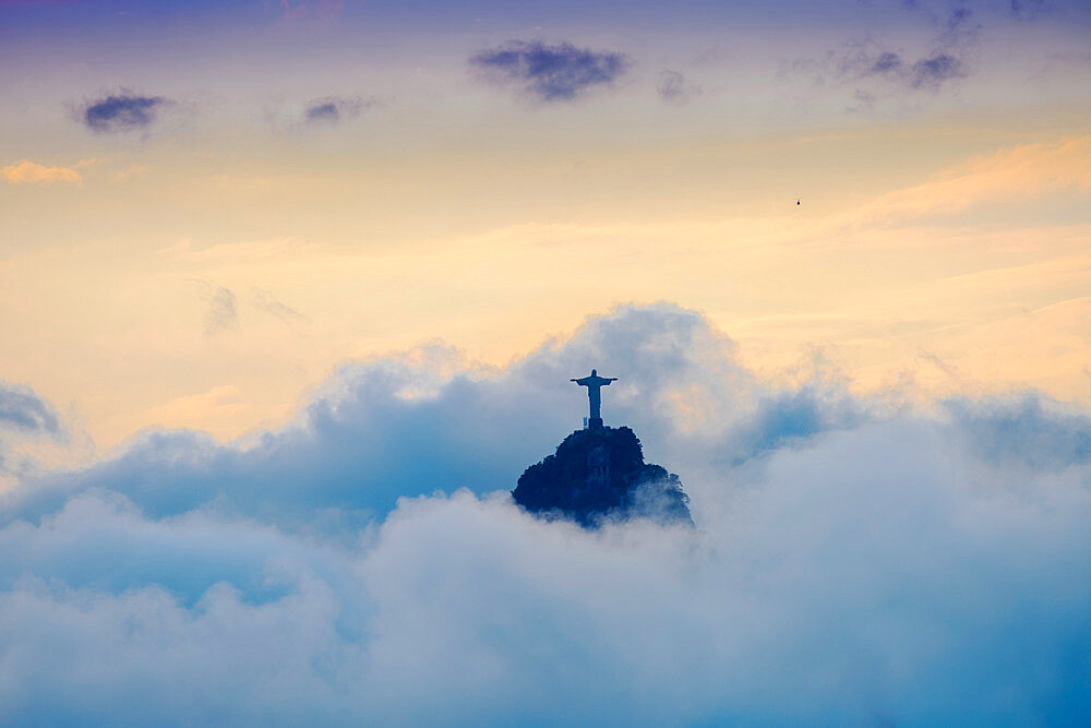 The Christ Statue (Cristo Redentor) on the summit of Corcovado mountain in a sea of clouds, Rio de Janeiro, Brazil, South America