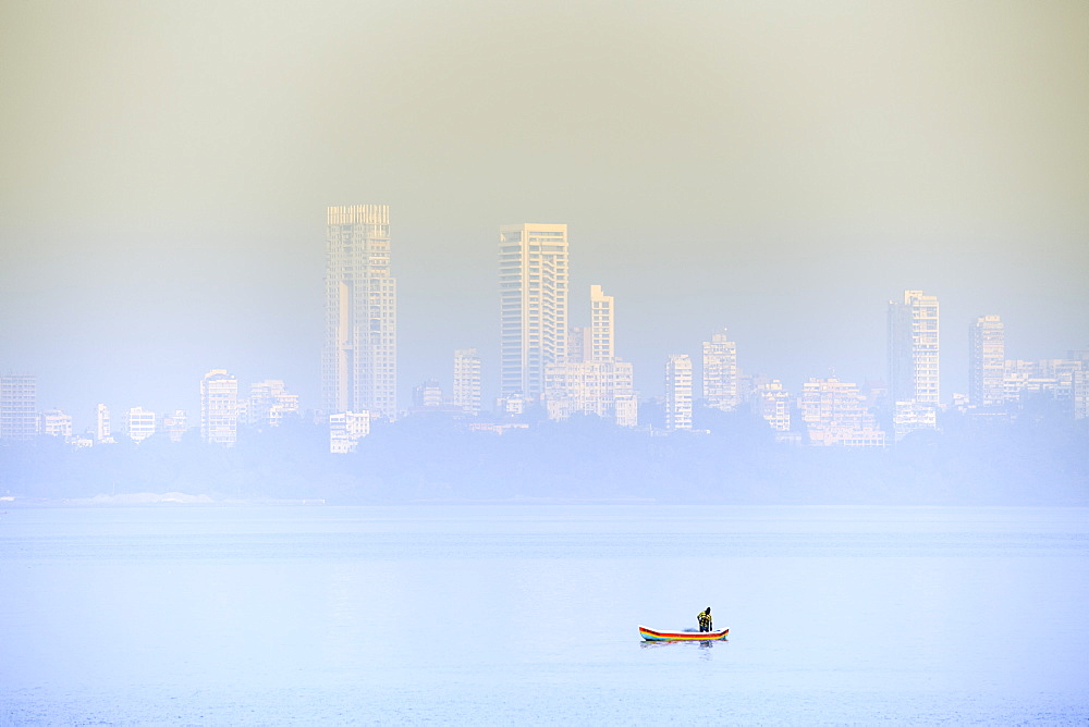 A fisherman in front of the skyscrapers of the Malabar Hills in Mumbai (Bombay), Maharashtra, India, Asia