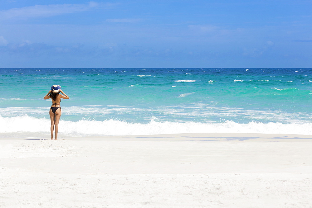 A young Brazilian woman in a bikini on Arraial do Cabo Beach, Rio de Janeiro State, Brazil, South America