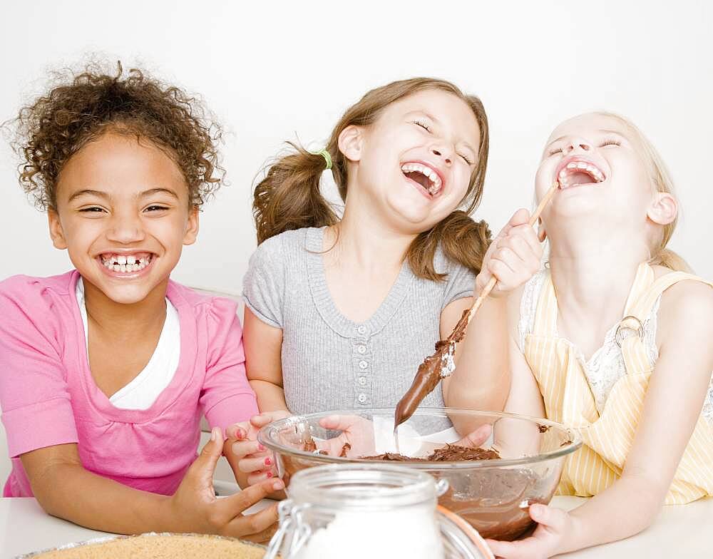 Multi-ethnic girls making batter