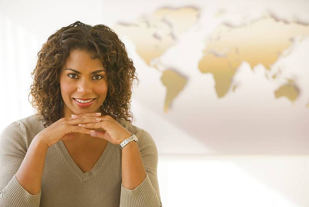 African businesswoman in front of world map