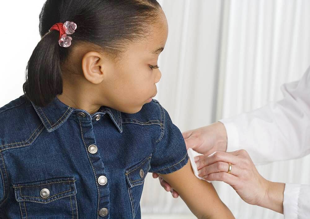 Young girl getting a shot