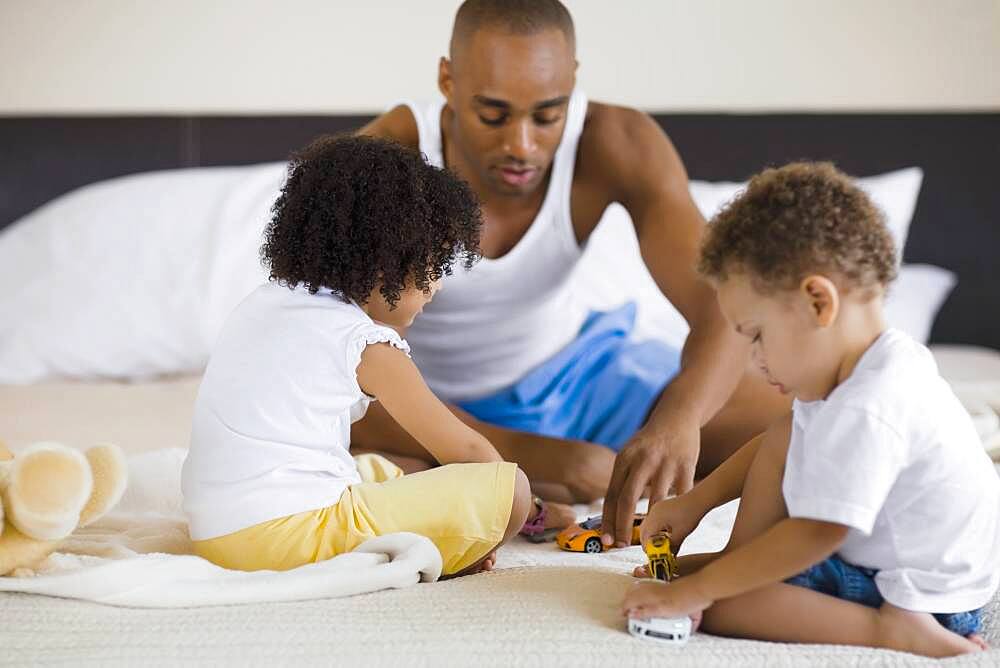 African father playing with children