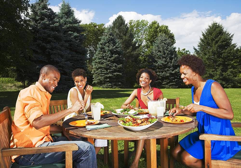 African American friends eating outdoors