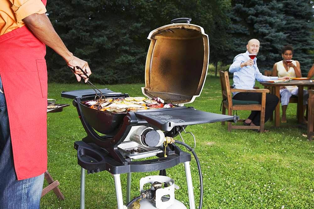 Multi-ethnic friends having barbecue