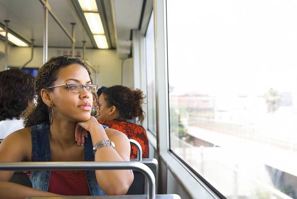 African woman riding on train