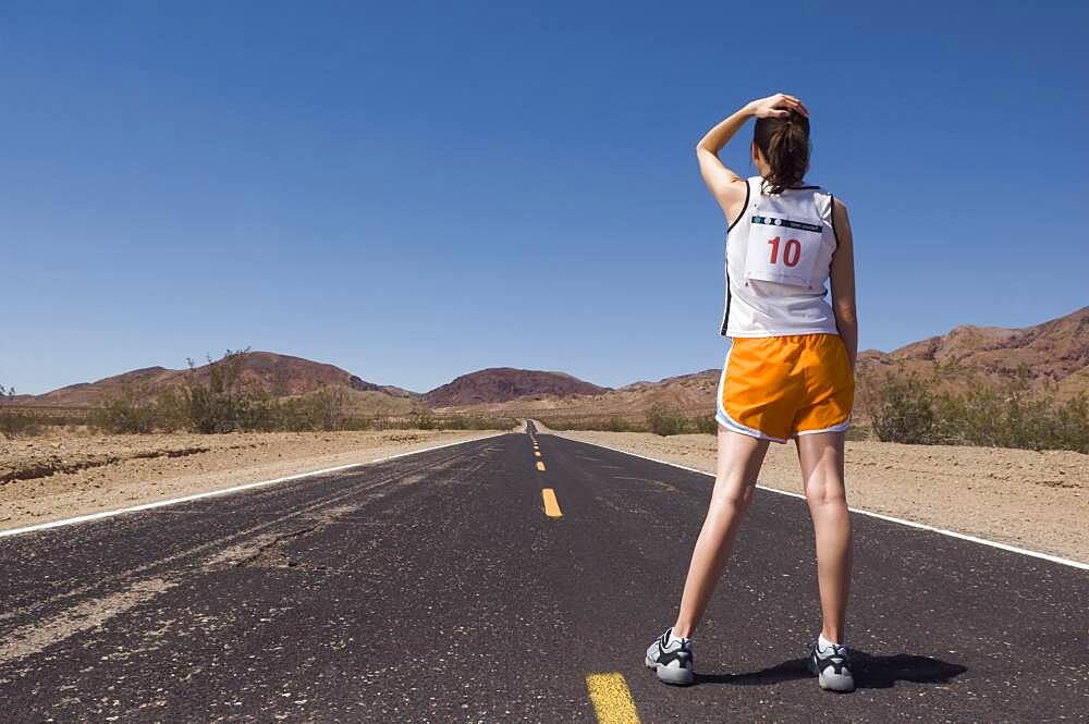 Mixed Race female runner on road