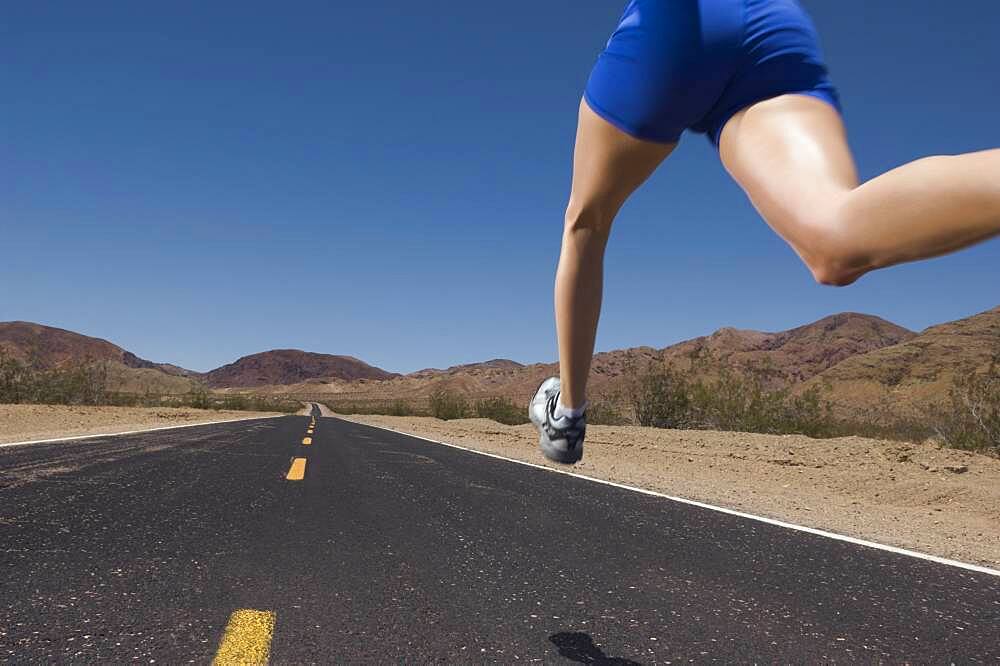 Mixed Race woman running on road