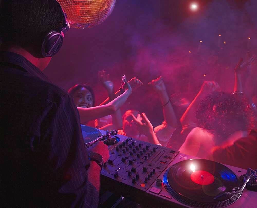 Hispanic dj playing at nightclub