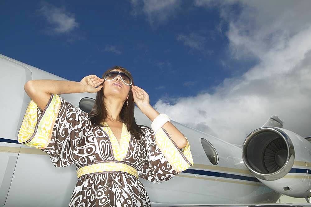 Woman standing in front of small jet