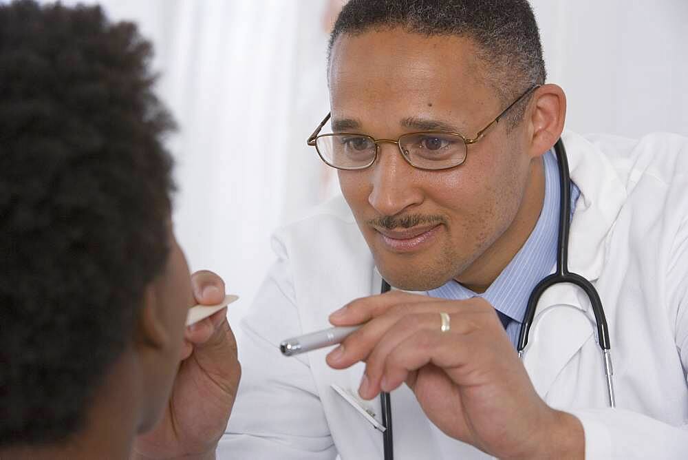 African doctor examining patient