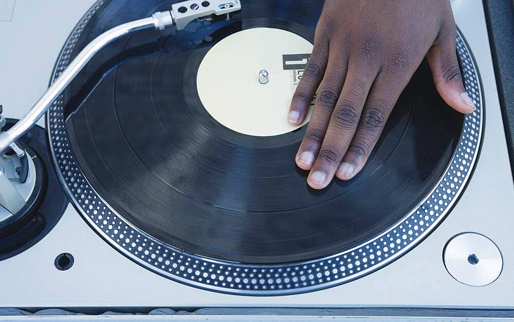 Man spinning vinyl on a turntable