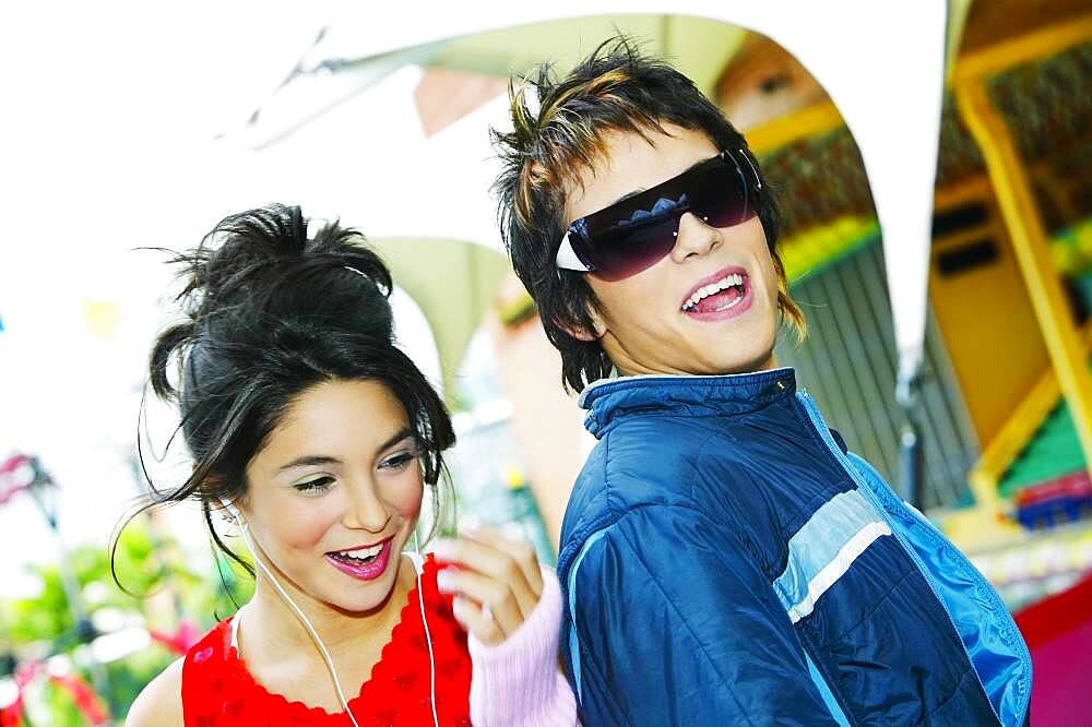 Young Hispanic couple smiling at carnival