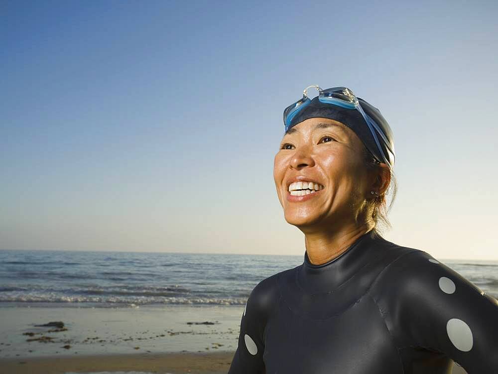 Asian woman wearing wetsuit and goggles