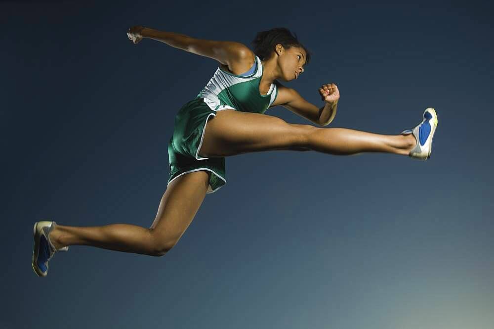 African American female athlete jumping