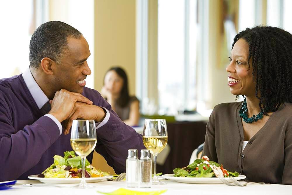 African American couple talking at restaurant