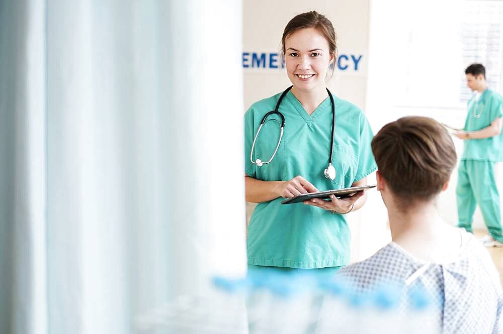 Doctor talking to patient in hospital emergency room