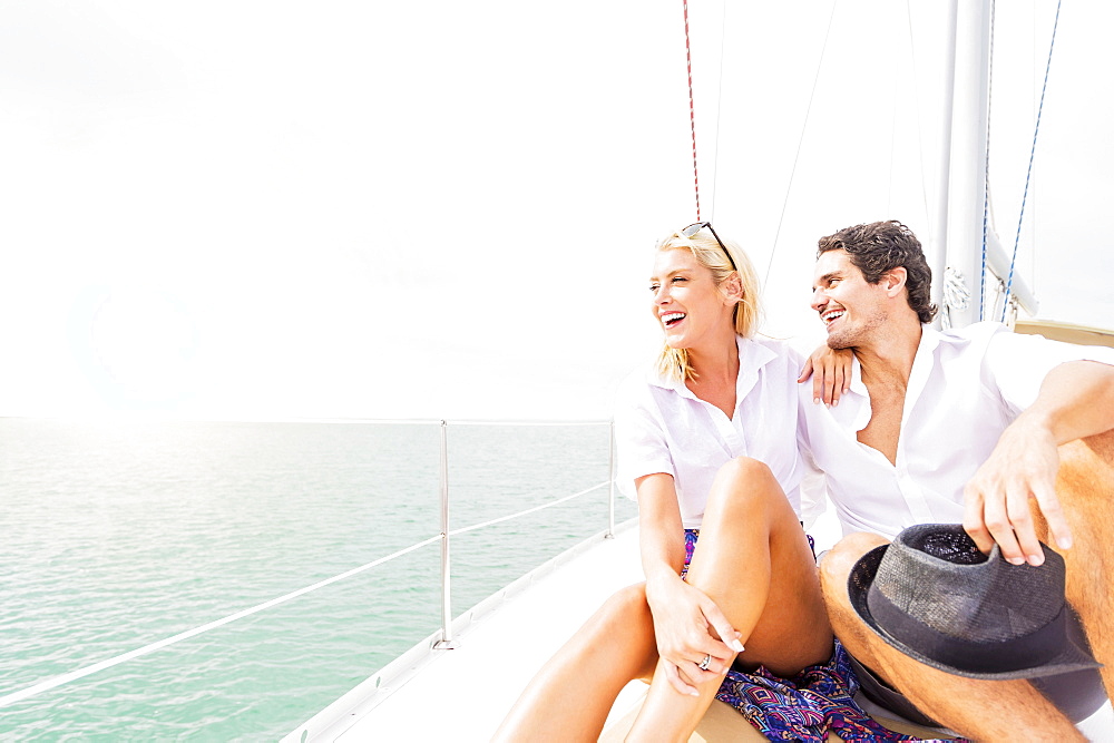 Couple hugging on deck of sailboat