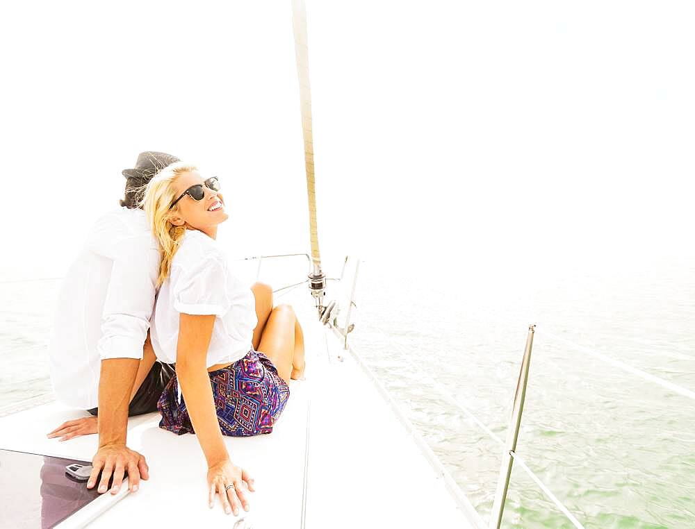 Couple cuddling on deck of sailboat