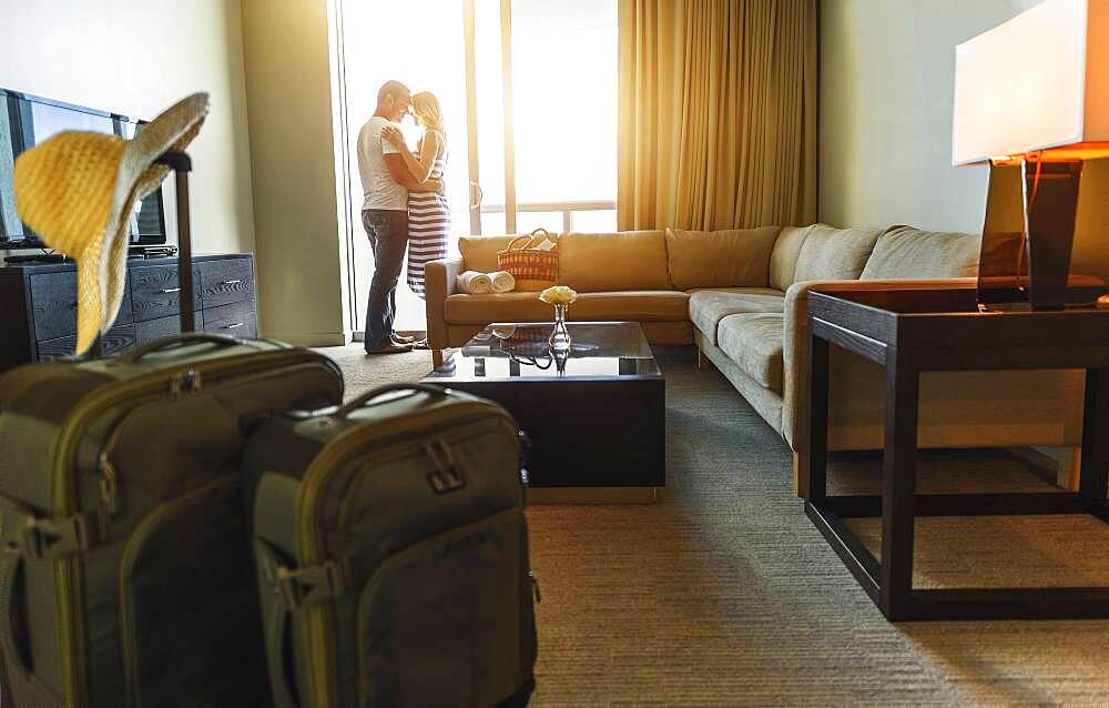 Couple hugging in hotel room