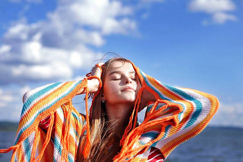 Caucasian teenage girl smiling with shawl