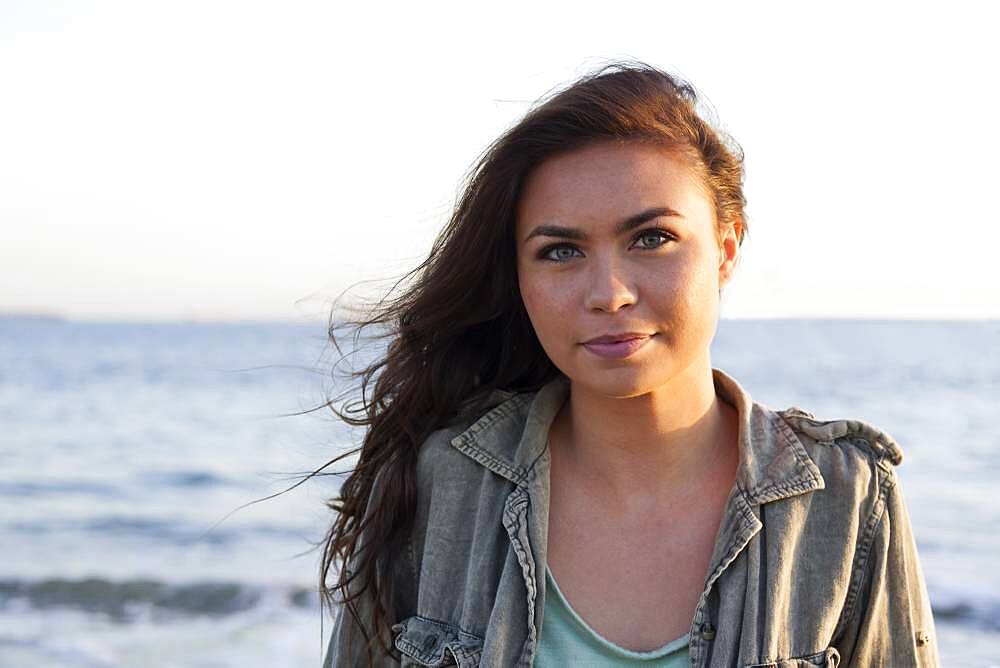 Mixed race woman near ocean