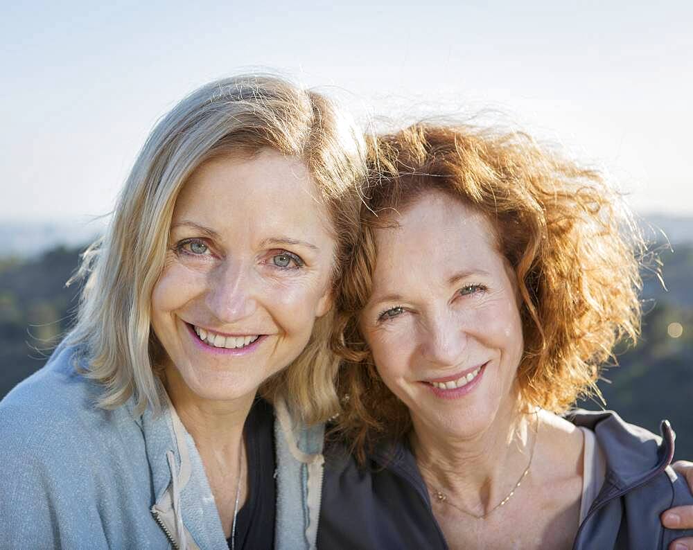 Close up of smiling Caucasian women hugging