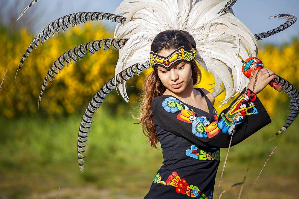 Native American woman in traditional headdress performing ceremony