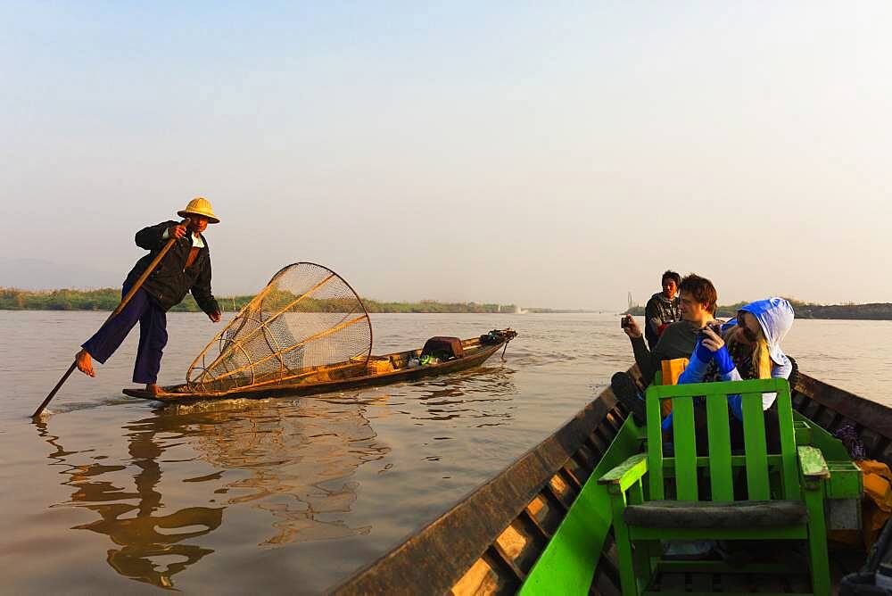 Tourists riding in canoe on rural lake