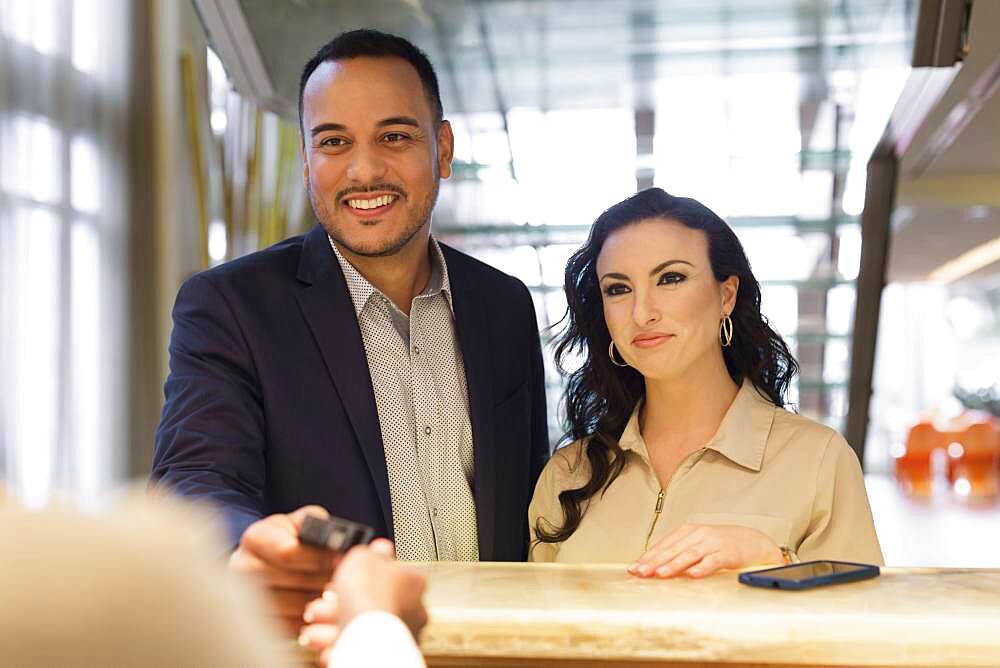 Business people checking into hotel with concierge