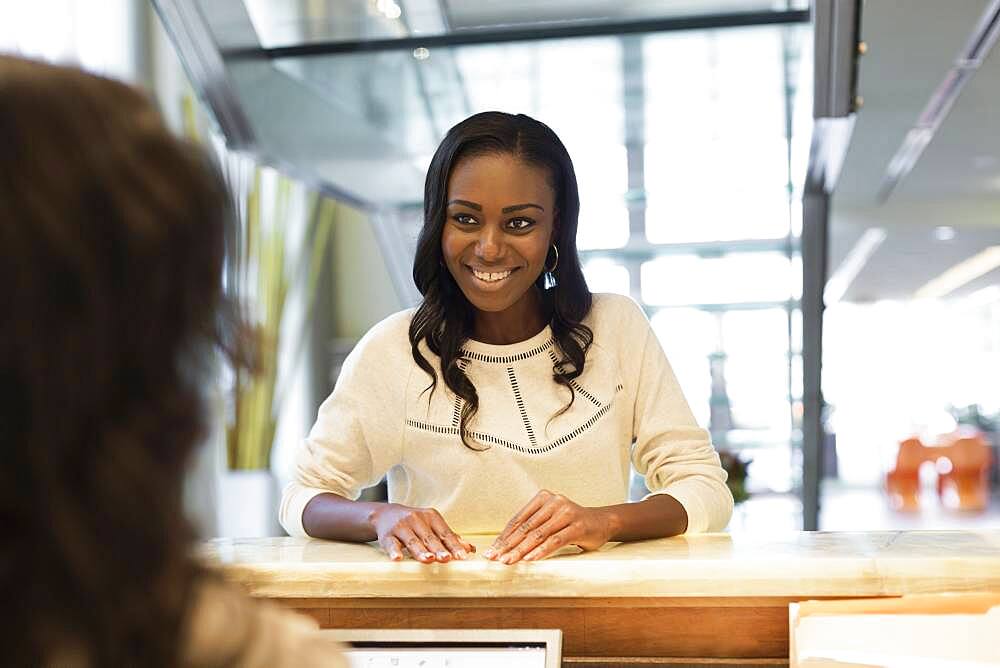 Businesswoman checking into hotel with concierge