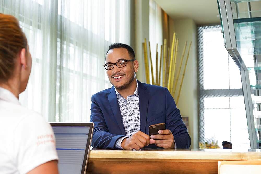 Businessman checking into hotel with concierge