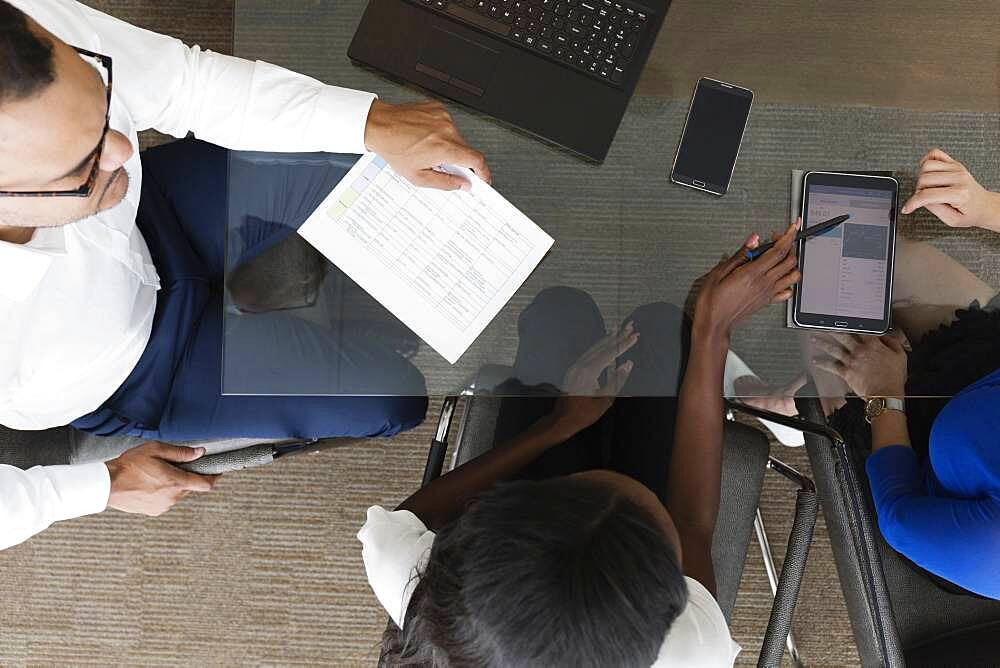 Overhead view of business people talking in office meeting