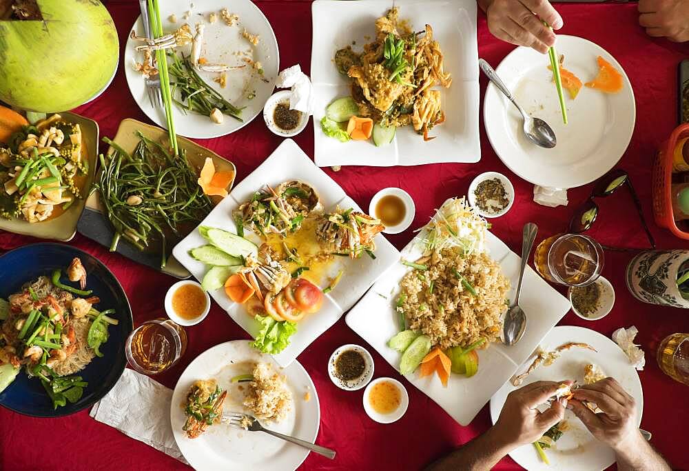 Overhead view of seafood and salad dishes on table