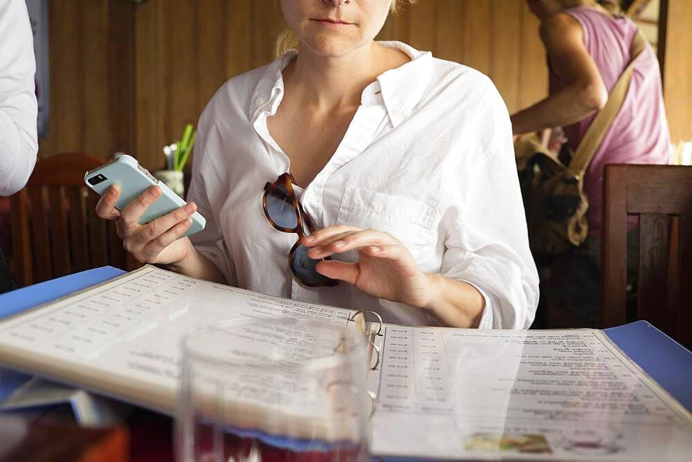 Caucasian woman reading menu in restaurant