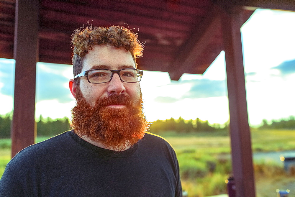 Caucasian man standing on patio in remote field