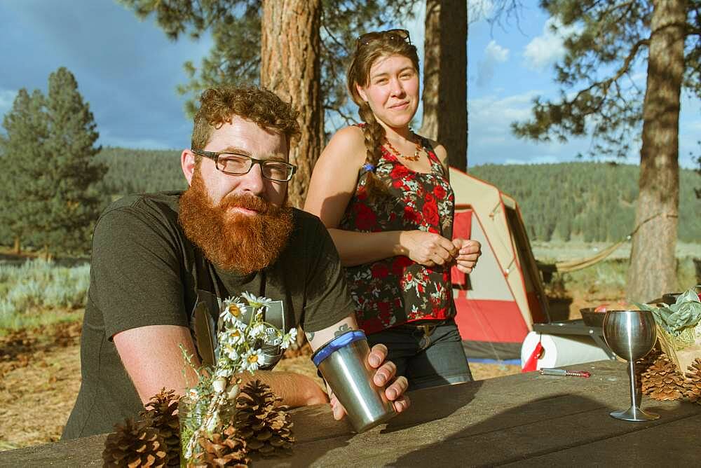 Caucasian couple relaxing at campsite