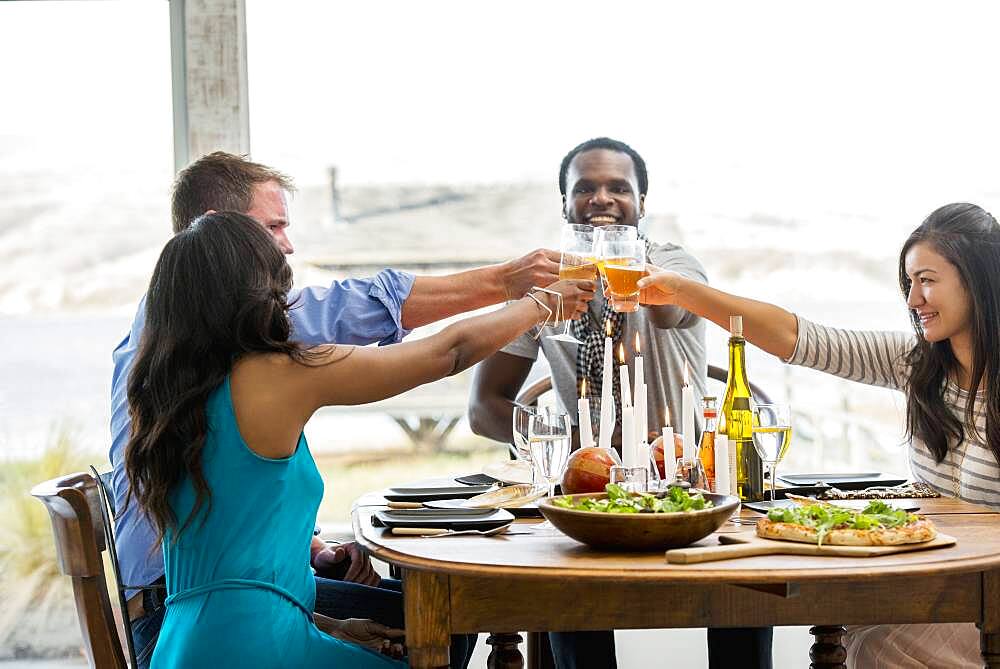 Friends toasting at dining room table