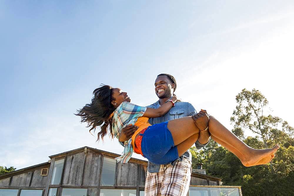 African American man carrying girlfriend