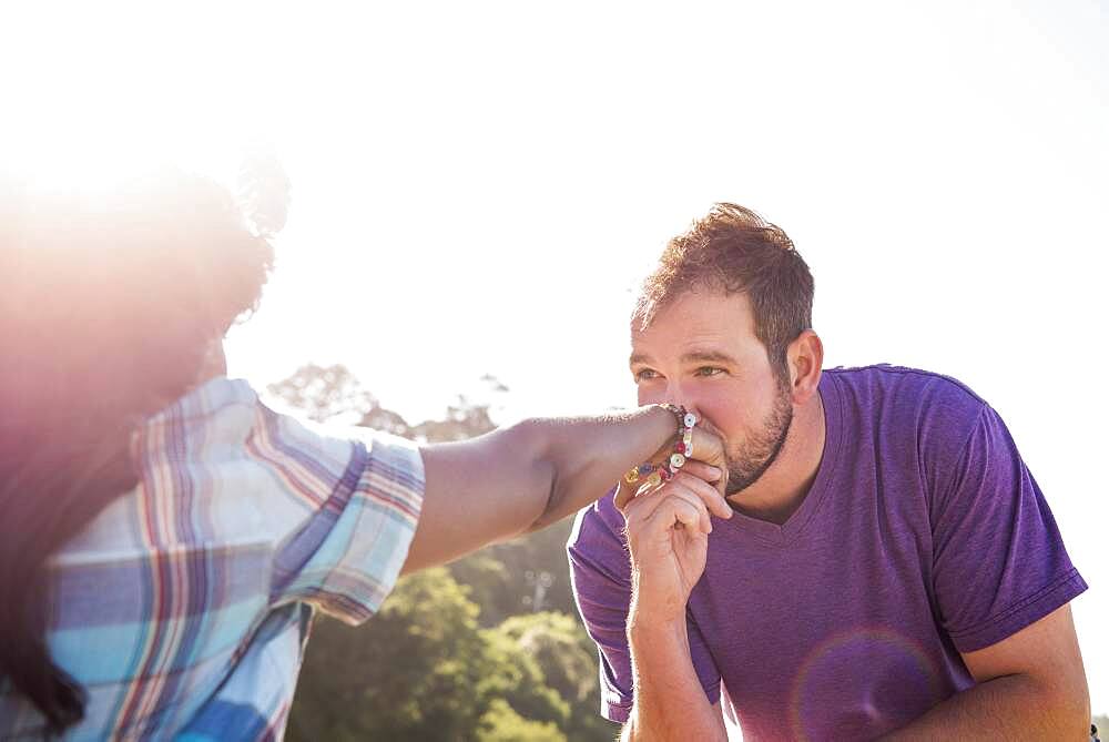 Man kissing hand of girlfriend