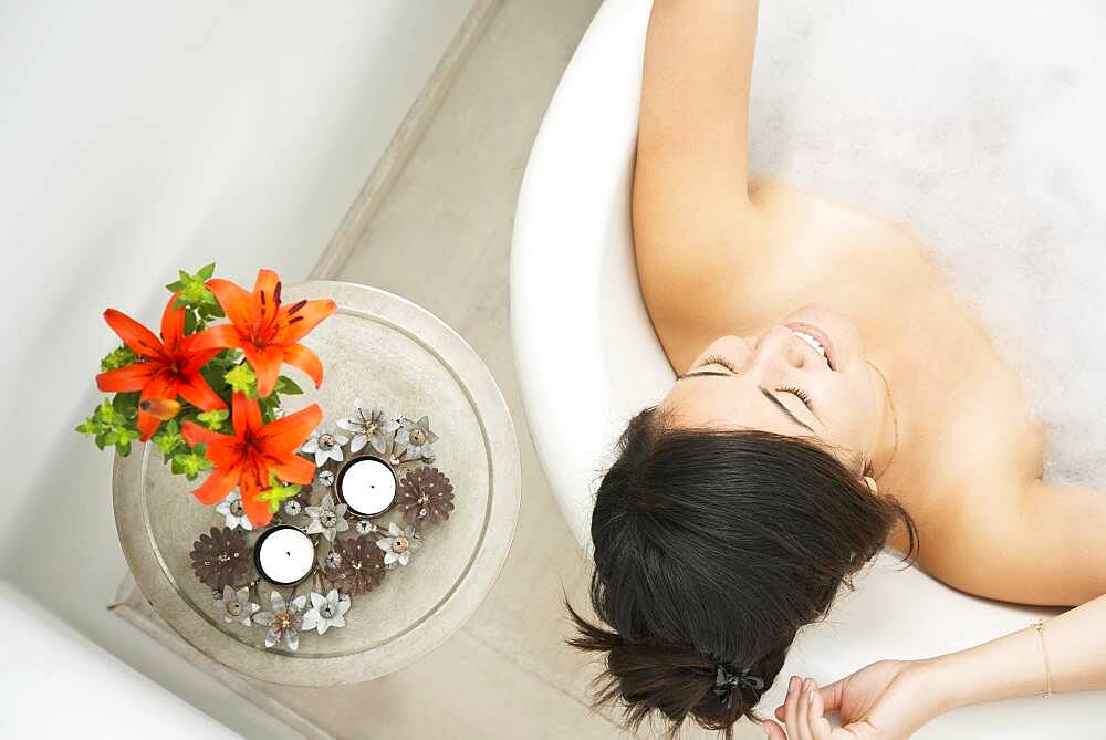 Woman relaxing in bubble bath