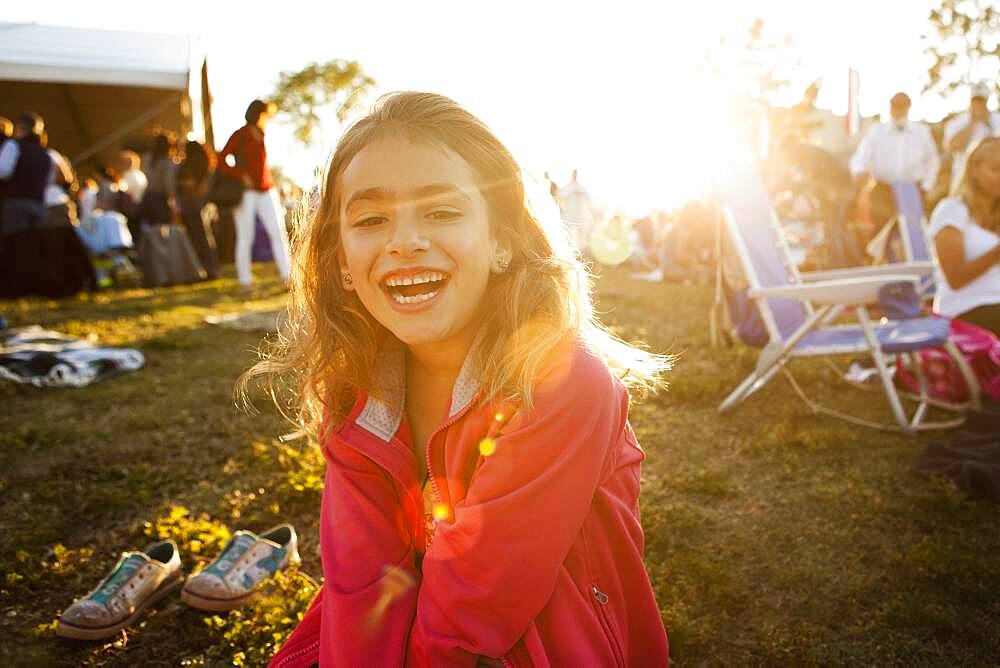 Mixed race girl laughing in park