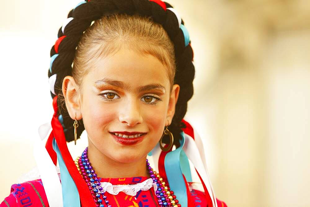 Mixed race girl wearing traditional makeup and dress