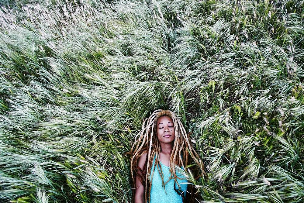 Black woman laying in grass