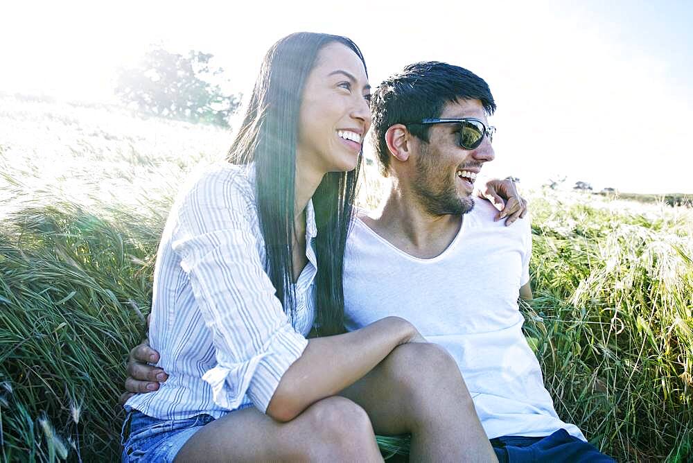 Couple hugging in field