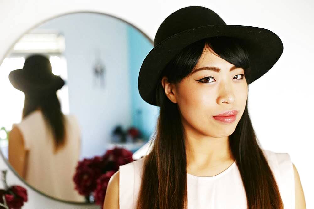 Japanese woman standing at mirror