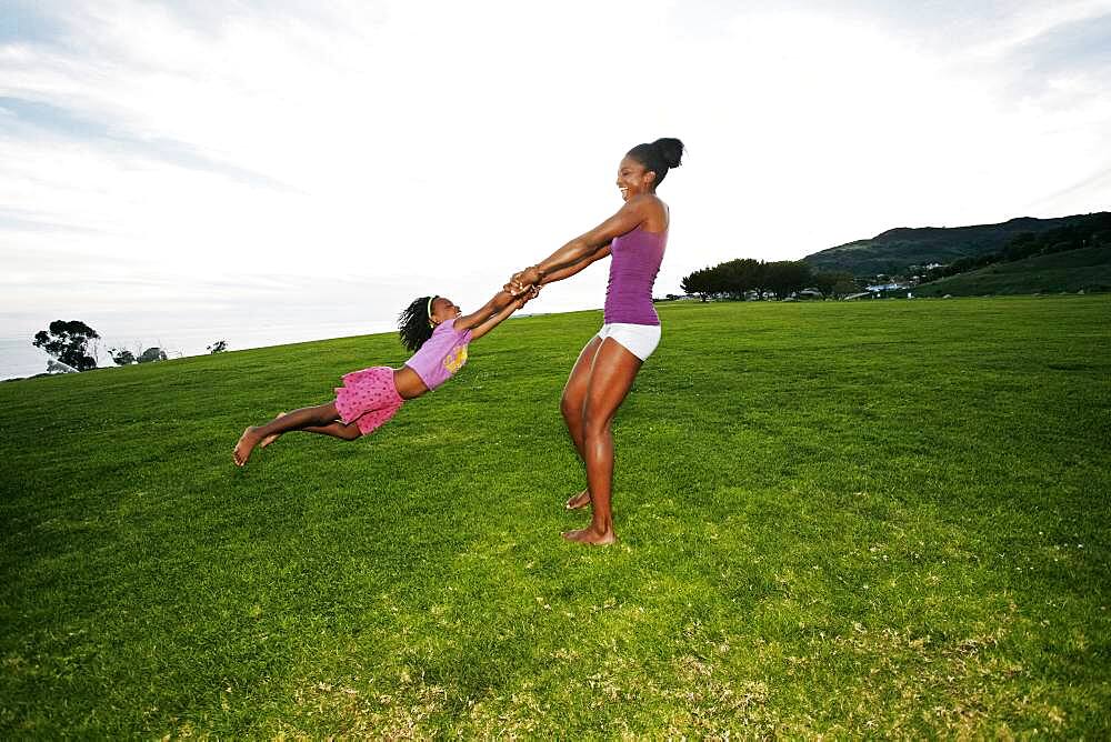 Mother and daughter playing in park